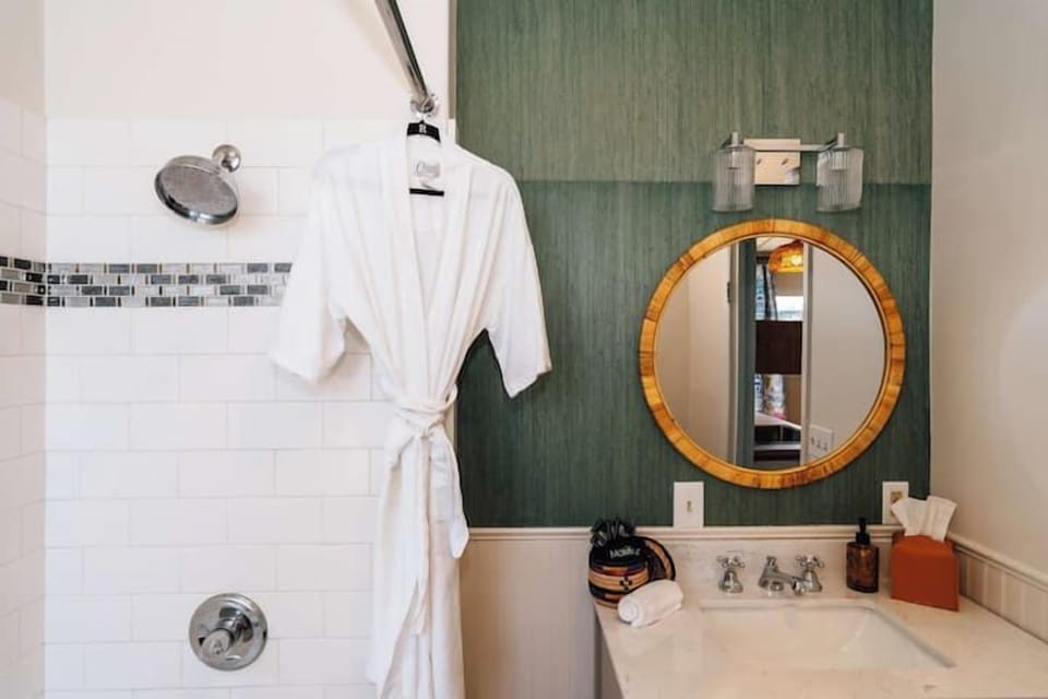 Swank 5: Contemporary bathroom featuring a soaking tub, shower combination, and modern vanity sink.