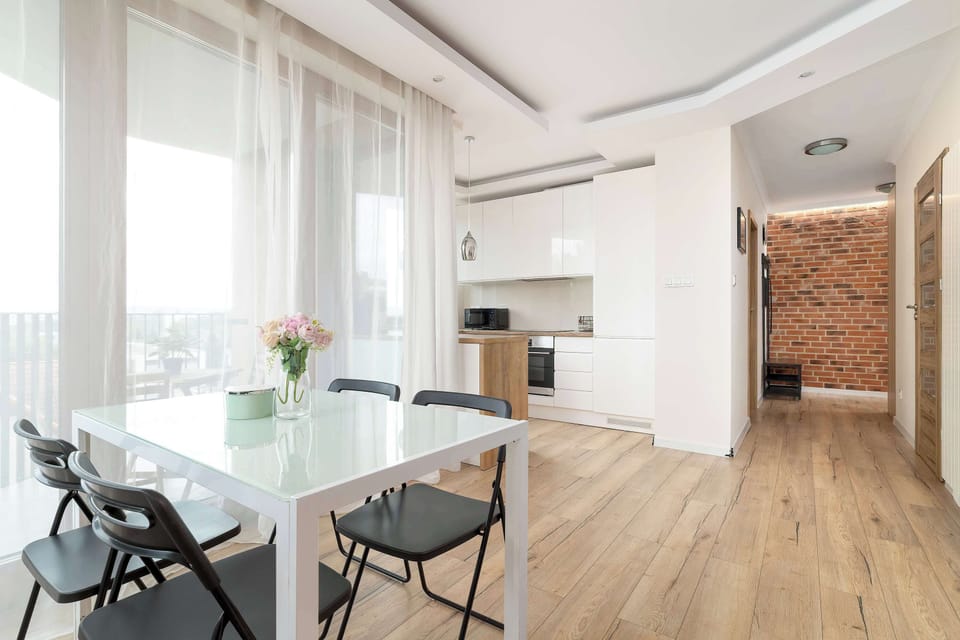 Bright and airy open-plan living and dining area seamlessly connected to the fully equipped kitchenette, creating spacious and functional layout.