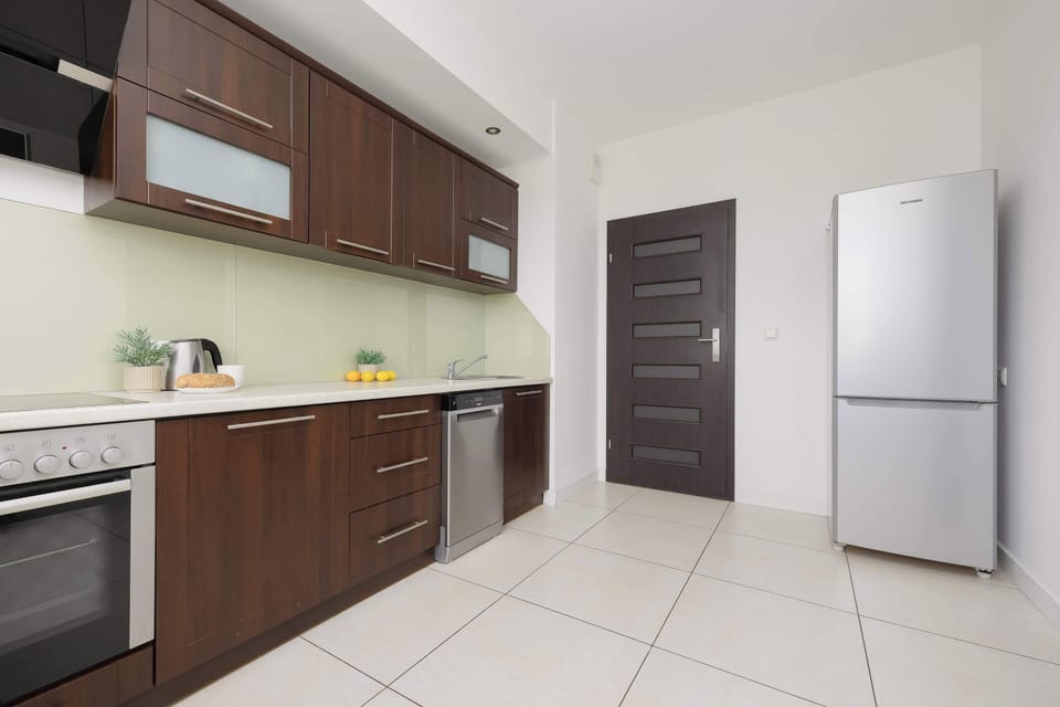 Well-equipped kitchenette with a fridge, oven, and generous storage space.