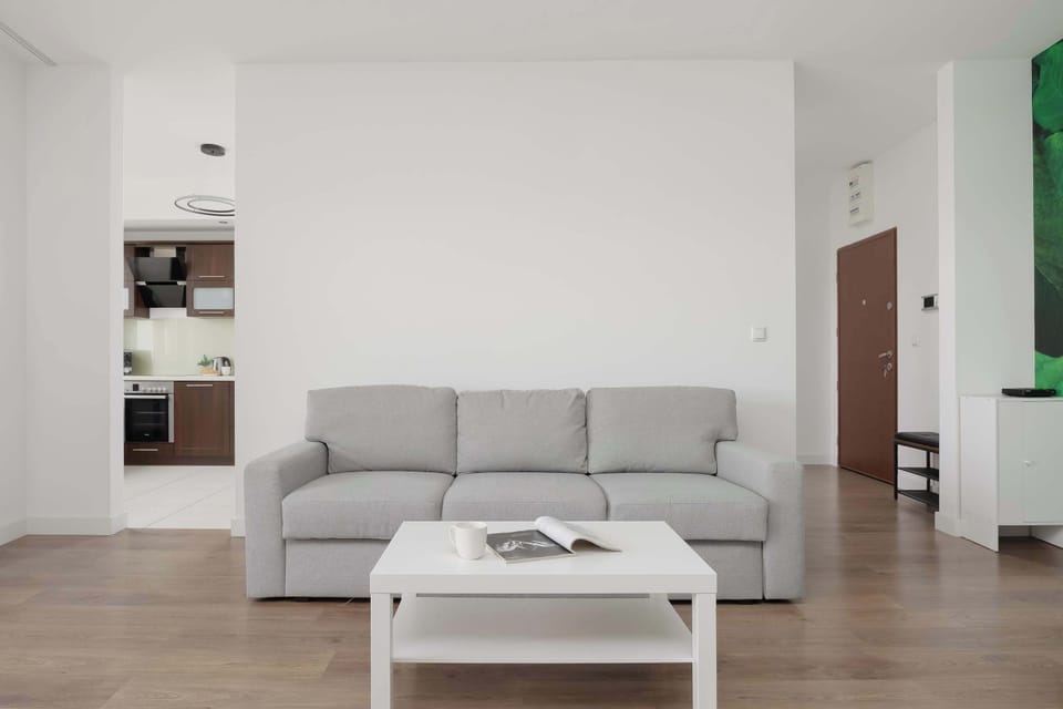 Another view of the bright living room with a comfortable seating area.
