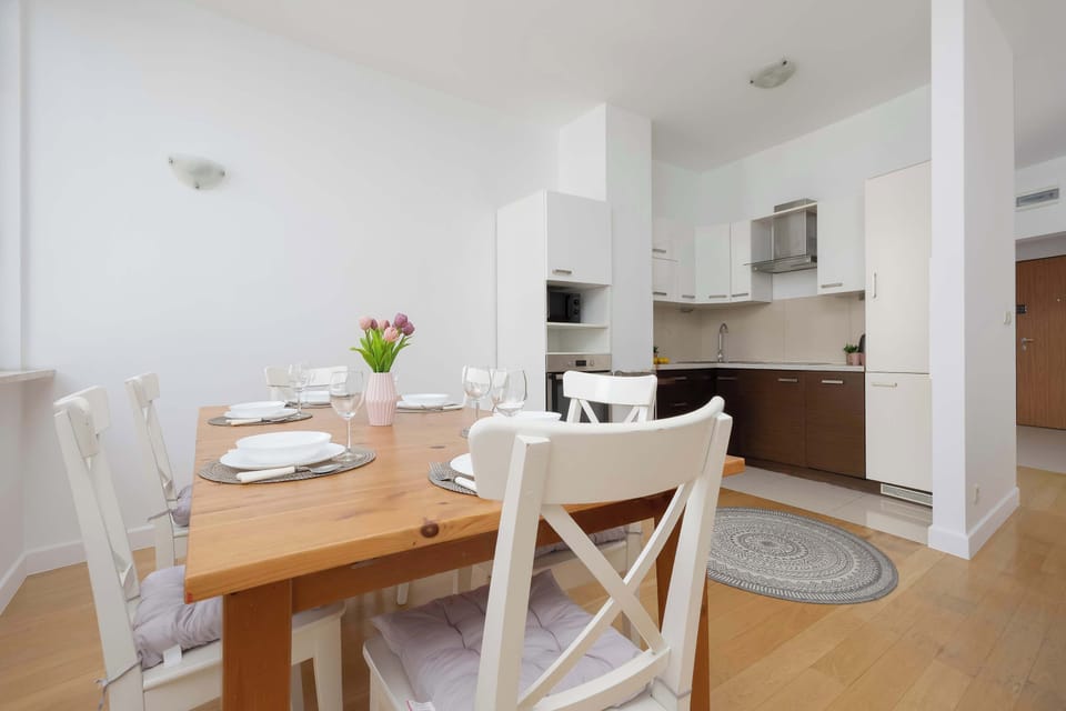 Open-plan kitchenette connected to the dining area, equipped with modern appliances and functional storage.
