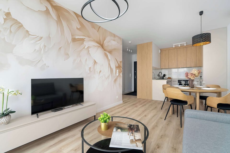 Spacious living area combining a lounge space, dining area, and kitchenette in an open-plan layout.