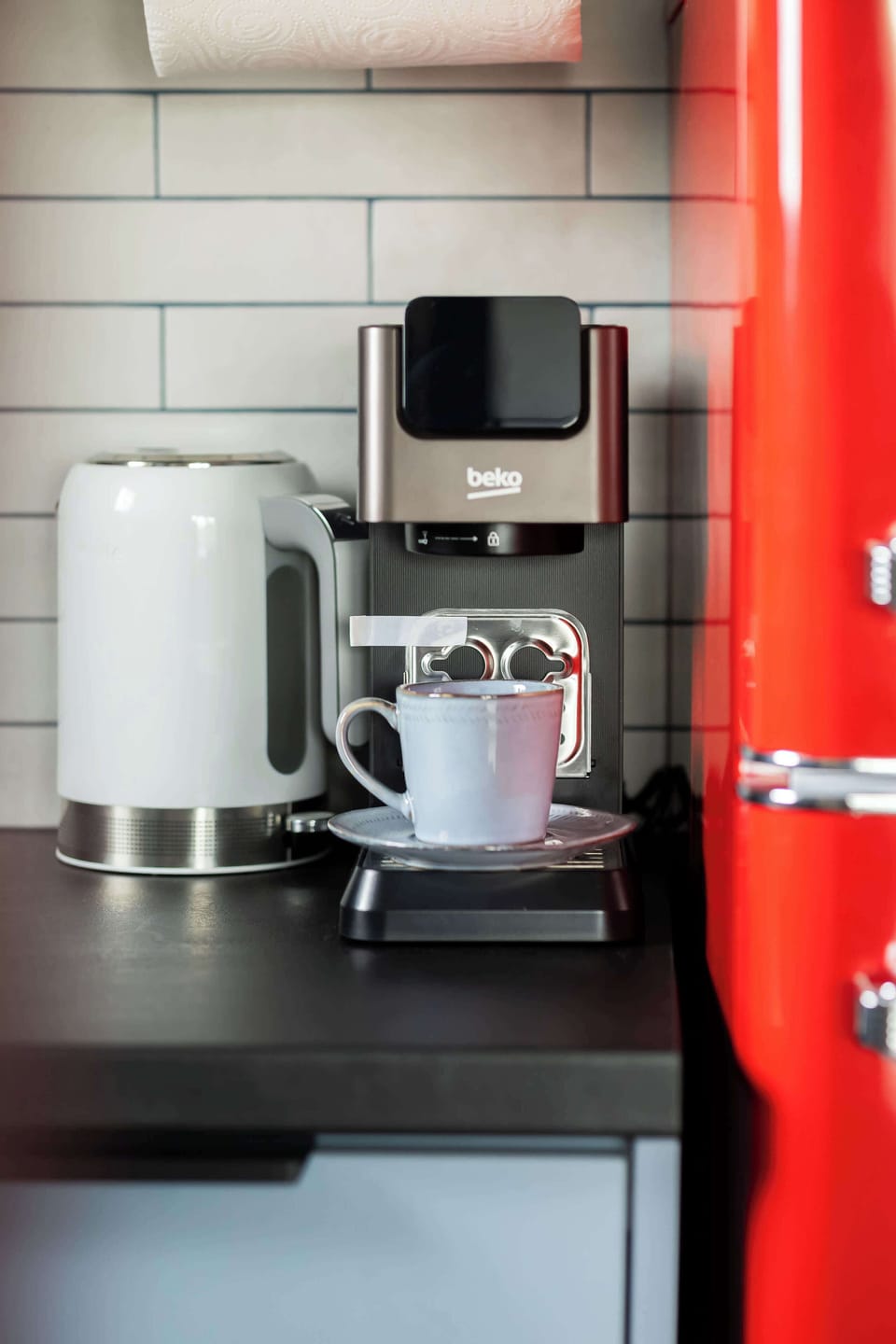 Coffee station with a coffee machine, electric kettle, and the retro-style refrigerator.