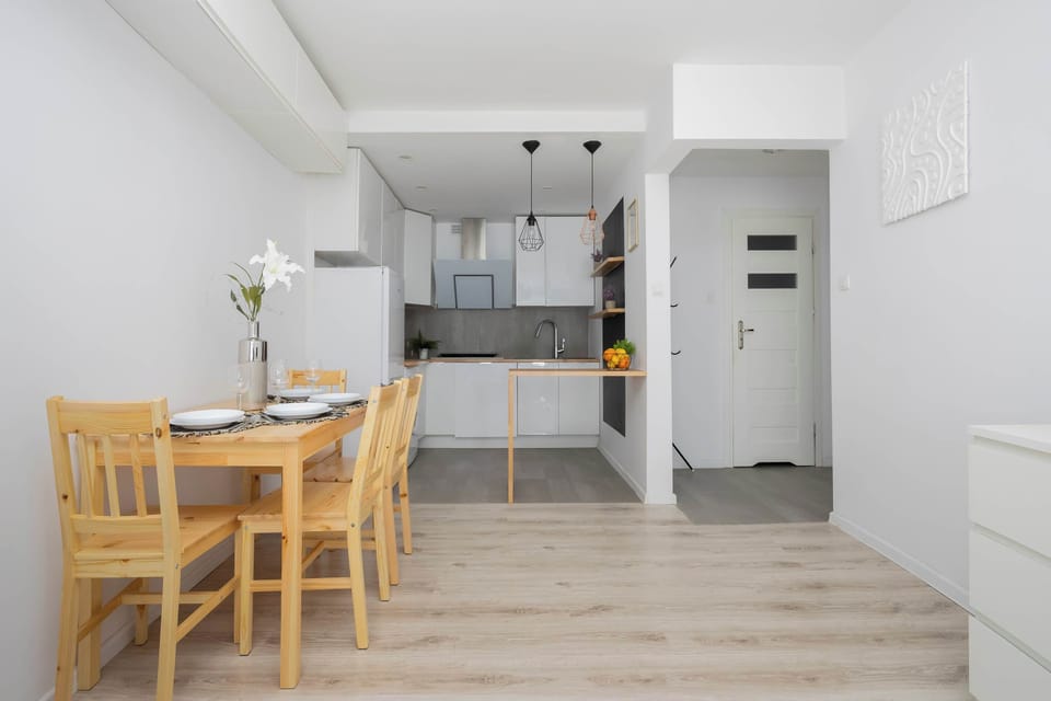 Contemporary open-plan kitchenette with modern cabinets, oven, and functional design.