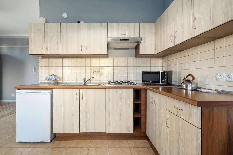 Well-equipped kitchenette with modern appliances, ample storage, and everything needed for everyday cooking.