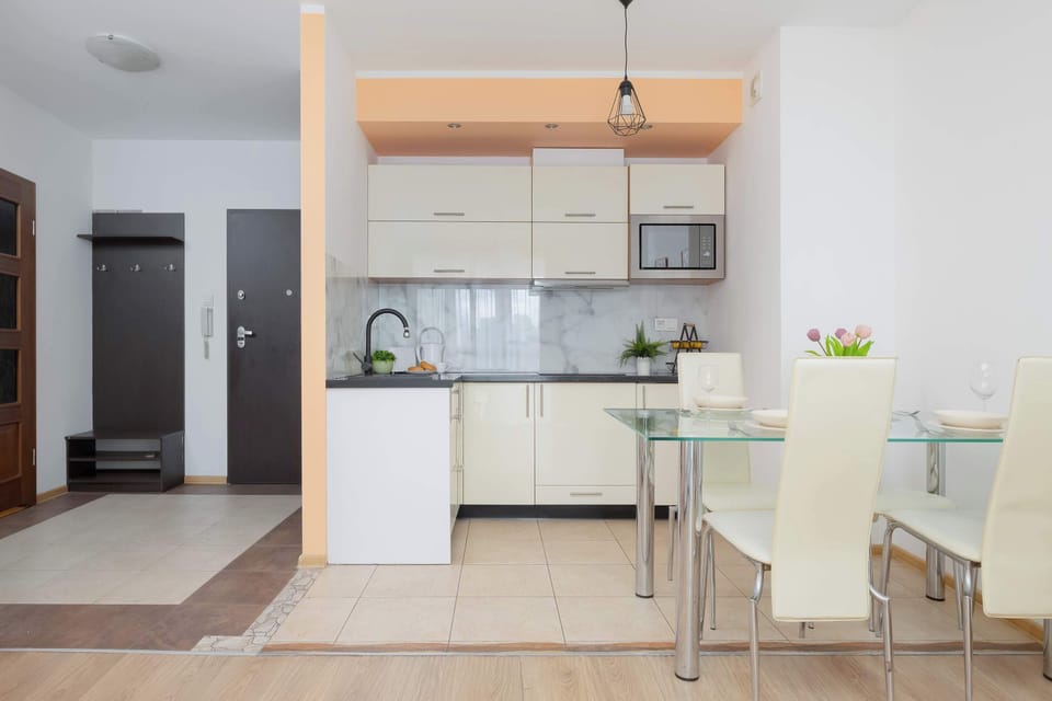 Fully equipped kitchenette with cabinets, microwave and cooking area.