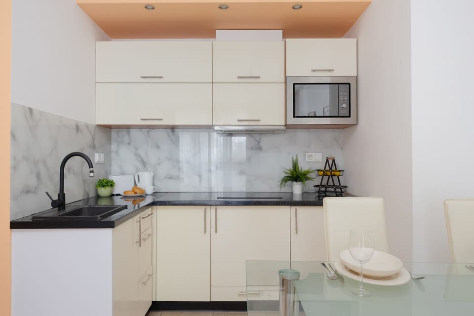 Fully equipped kitchenette with cabinets, microwave and cooking area.