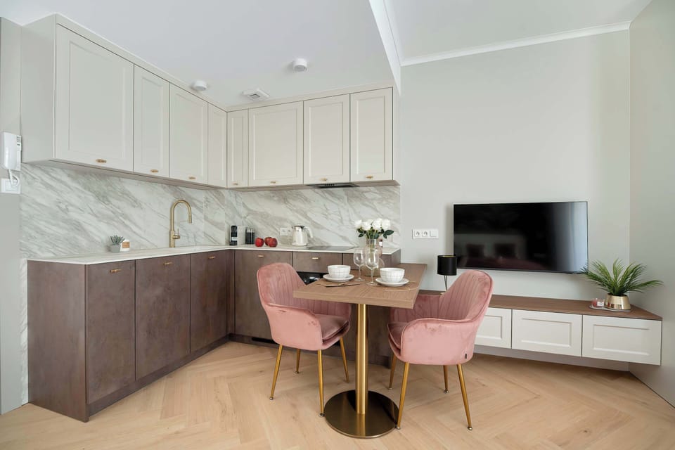 A fully equipped kitchenette with a dining table and comfortable seating. The modern design creates a welcoming atmosphere.