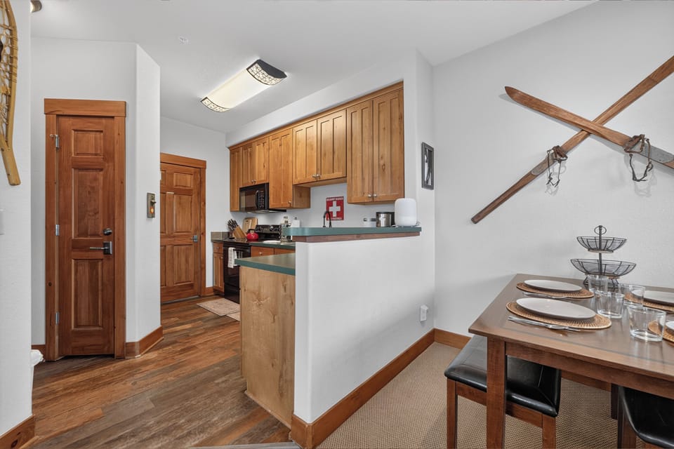 Cozy mountain retreat with warm wood tones, fully equipped kitchen, and rustic ski decor. Perfect for shared meals and alpine adventures.