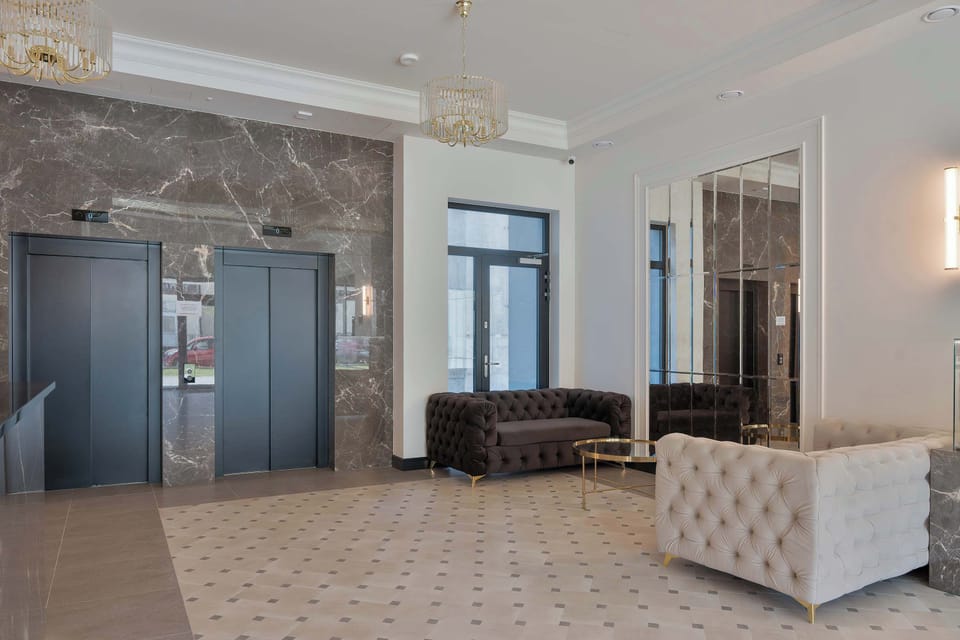 A spacious and elegant lobby with comfortable seating. Large windows create a bright and welcoming atmosphere.