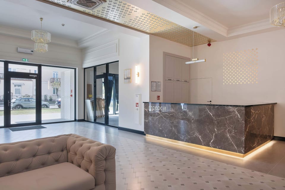 A stylish reception area with modern décor and a seating space. The open layout gives the interior a luxurious feel.