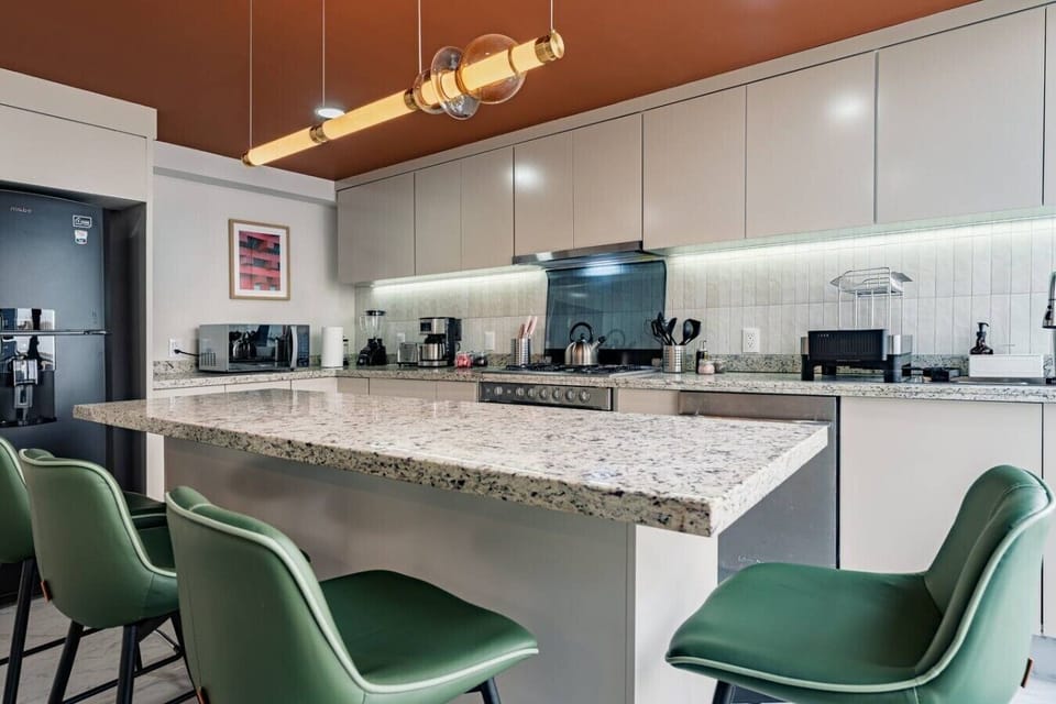 Spacious modern kitchen with a large island, generous prep space, and seating for four.