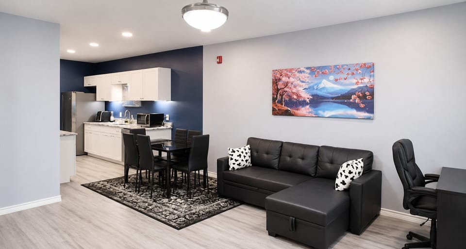 Living Room: Spacious with sofa bed, desk, 65” TV, blackout curtains.