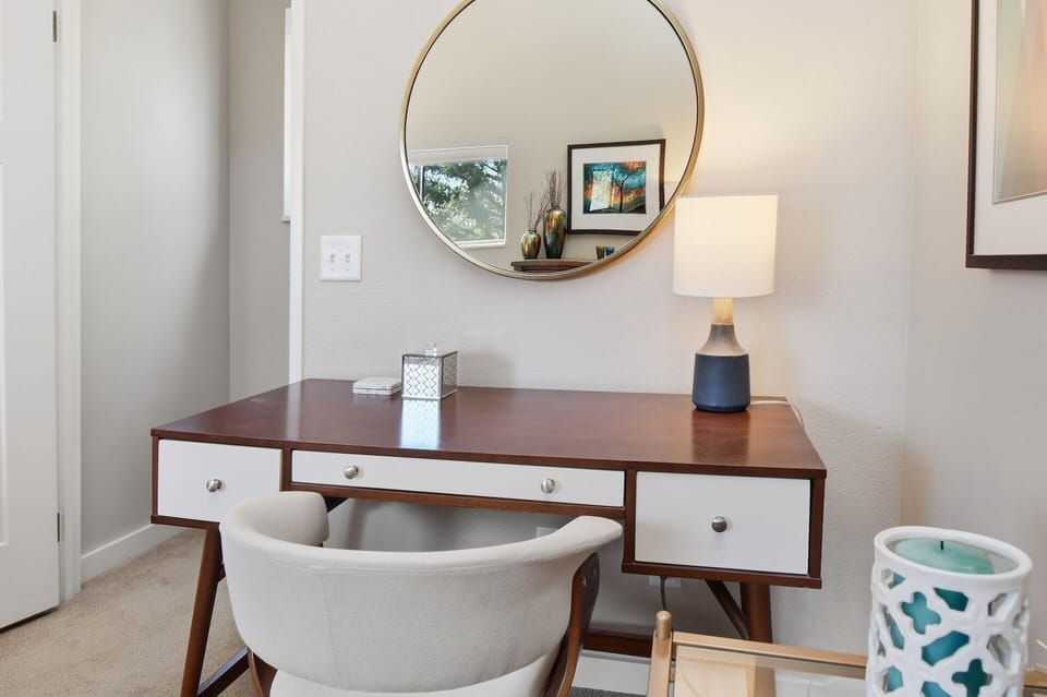 Freshen up at your stylish vanity area with a statement mirror and modern desk—perfect for getting ready or catching up on work in comfort.