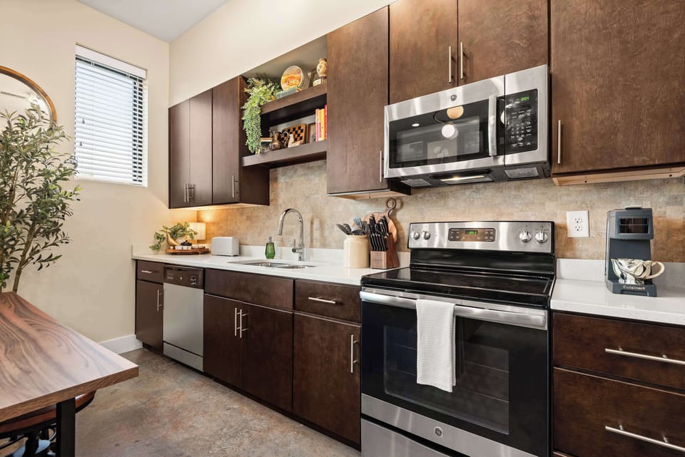 Full kitchen with range, microwave and coffee maker