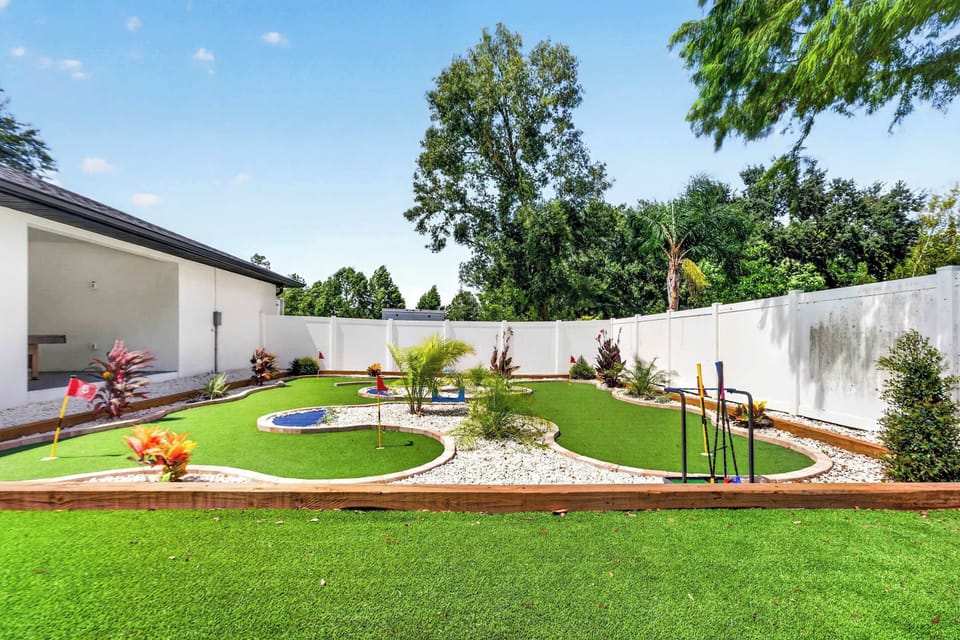 Private Backyard Mini-Golf Course with Lush Turf, Tropical Landscaping and Fun for Guests of All Ages