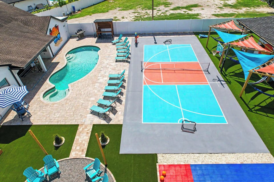 Resort-Style Backyard with Heated Pool, Pickleball & Basketball Court, and Plenty of Poolside Lounge Seating