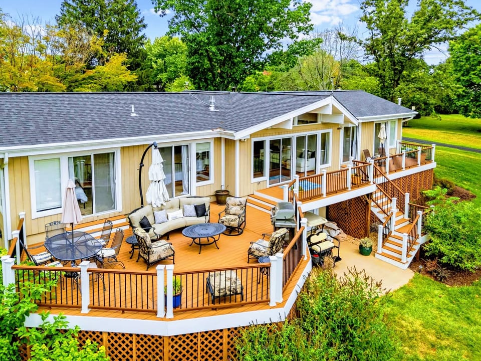 From Above - The full property from the water: wide-open lake frontage, wraparound decks, and a private double boathouse.