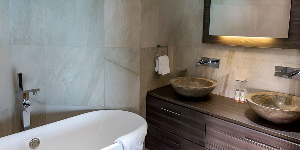 Soak and refresh in a spa-style bath with stone basins.