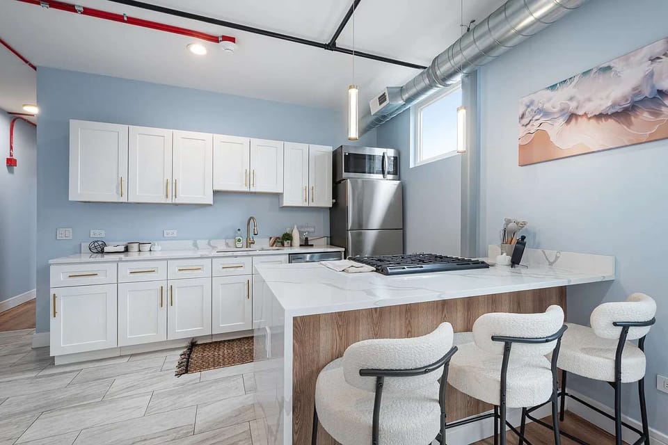 Contemporary dining area with seating for three, conveniently located next to the kitchen for easy meals, coffee, or gathering with family and friends.