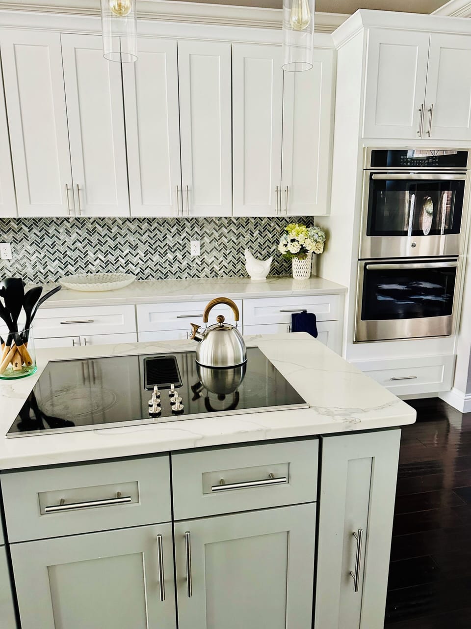 Modern kitchen with stainless steel appliances, island & Keurig coffee maker.