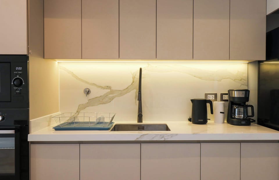 Fully equipped kitchen with coffee maker, sink, and essential appliances.