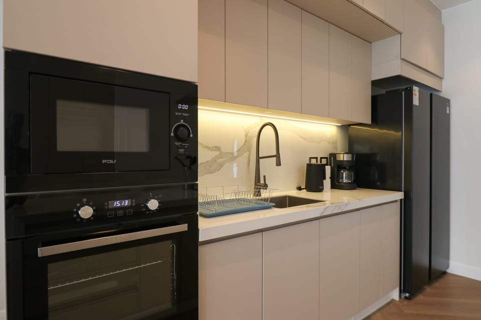 Modern kitchen featuring built-in appliances and ample storage space.