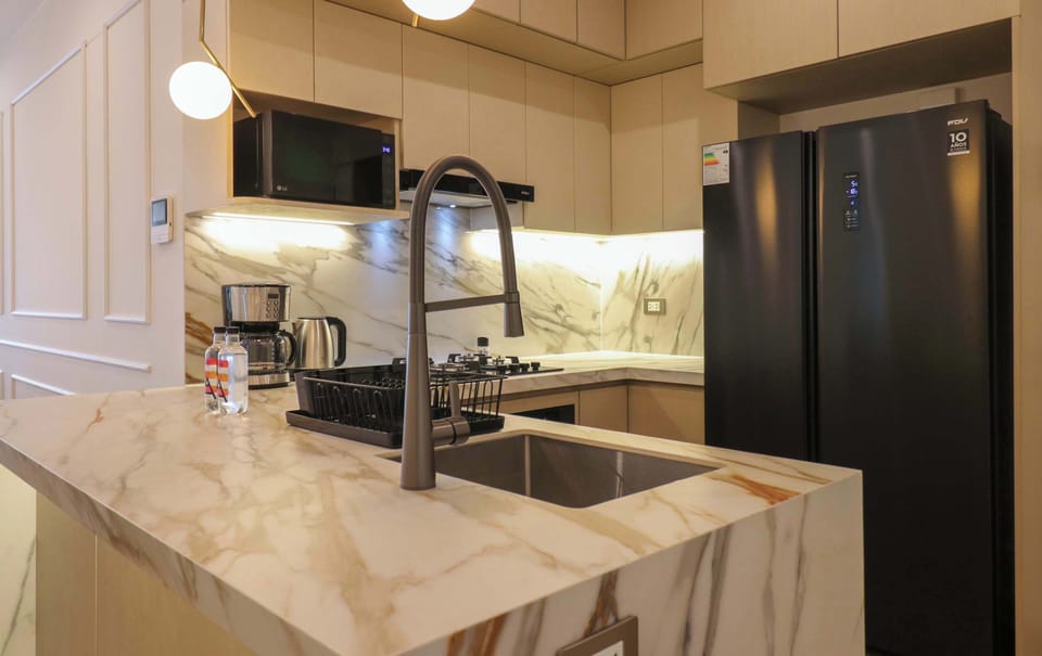 Modern kitchen island with marble countertop, perfect for preparing meals or enjoying breakfast.