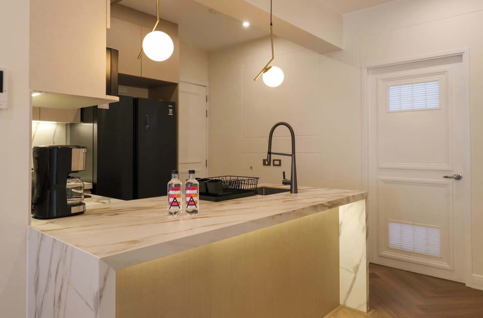 Contemporary kitchen area with ample storage and sleek finishes.