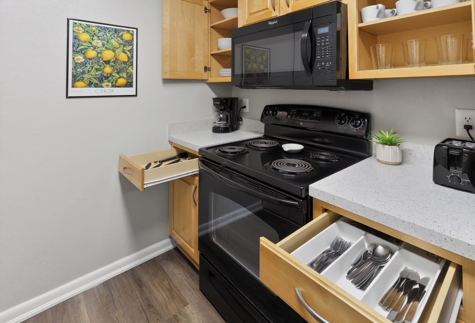 Bright, stocked kitchen with full-size appliances and coffee setup