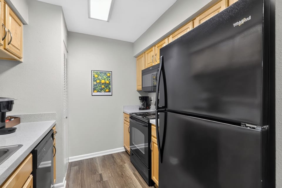 Bright galley kitchen with full-size appliances and coffee station