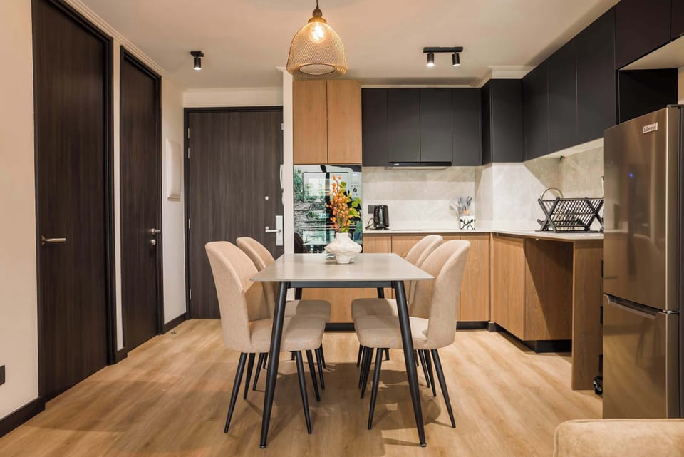 Modern dining area with sleek kitchen, perfect for family meals and gatherings.