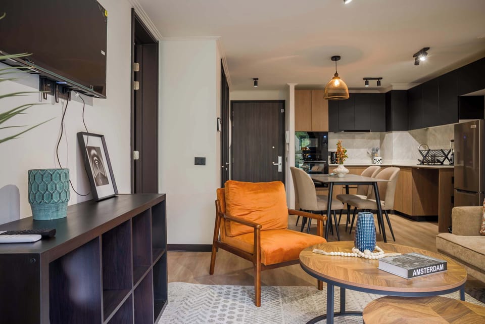 Cozy living area with modern amenities and a stylish kitchen, perfect for relaxing or entertaining.