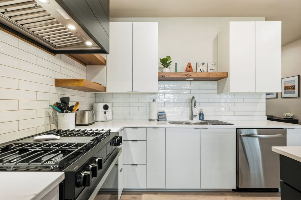 Stainless steel appliances and a complete collection of pots, pans, cookware, dishes, glassware, and utensils make meal preparation simple