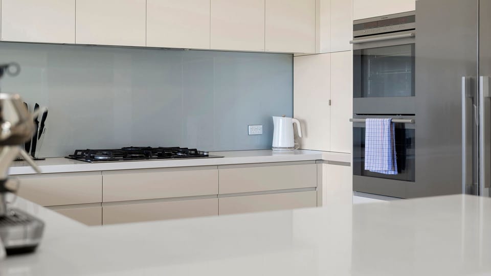The contemporary kitchen offers generous bench space and quality appliances.