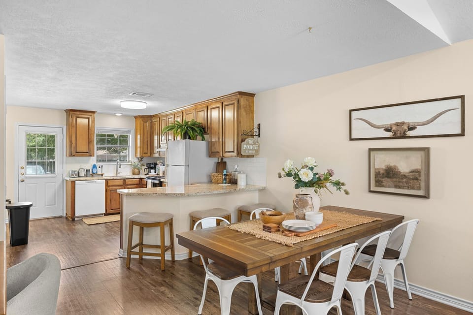 Bright open dining area with breakfast bar and warm, inviting kitchen