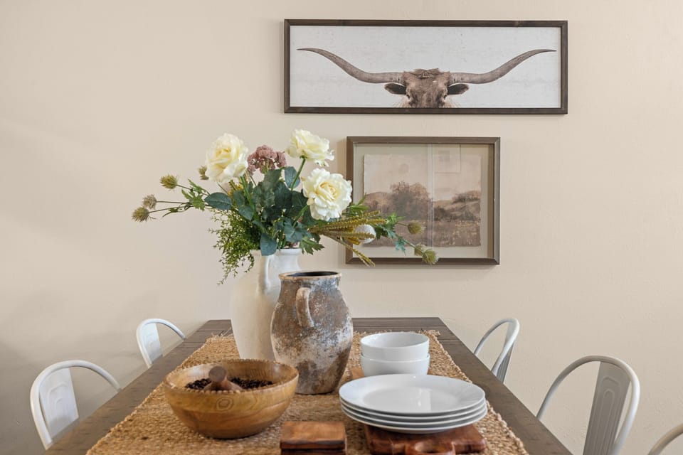 Charming farmhouse-style dining area with warm decor and guest-ready table