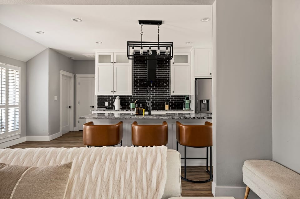 Contemporary kitchen with bar seating and a seamless layout that opens to the living area for easy entertaining.