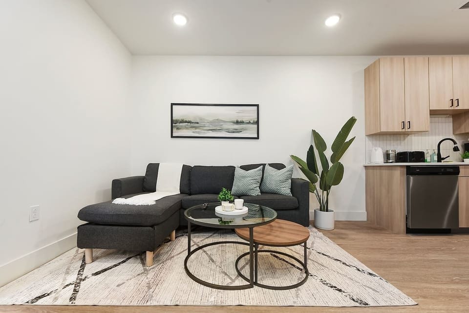 Cozy living area with a comfortable sectional sofa, stylish coffee tables, and a relaxing ambiance.