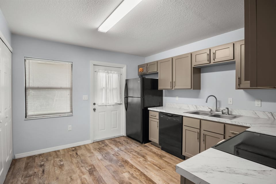 Unit #1 Left: The kitchen door connects to the backyard patio.