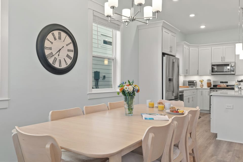 Gather for breakfast or dinner around the spacious dining table, with a bright, airy setting for shared meals.