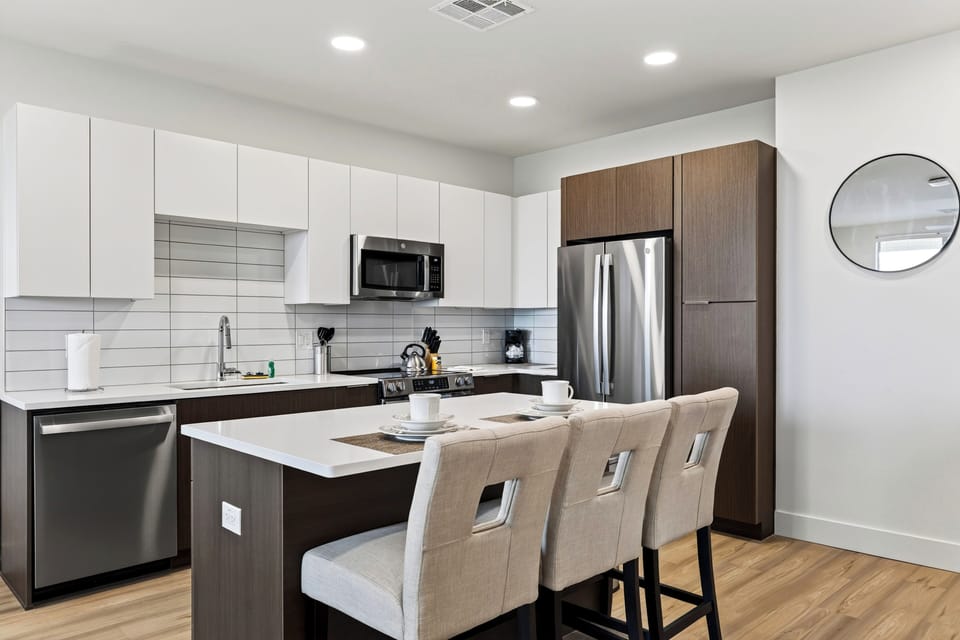 Prepare meals in the fully equipped kitchen, complete with modern appliances and island seating.