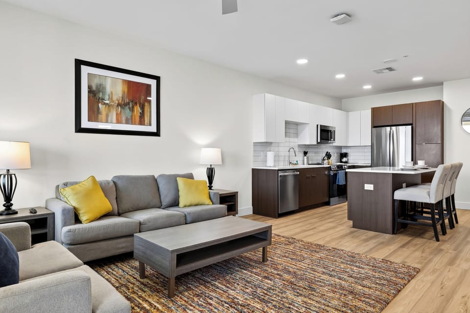 Relax in the comfortable open-concept living area, with a full kitchen and island seating close by.