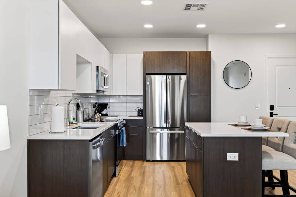Prepare meals in the fully equipped kitchen, complete with modern appliances and island seating.