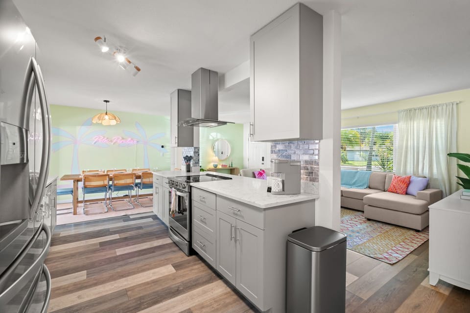 The kitchen area, dining area, and living room area in view.