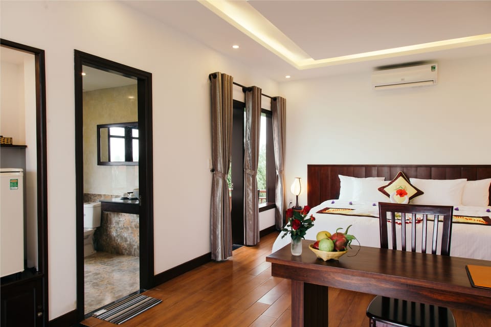 Deluxe Room, Pool View | Minibar, in-room safe, desk, laptop workspace