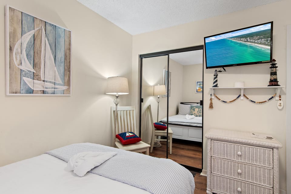 Guest bedroom features a TV, storage, and plenty of space to settle in