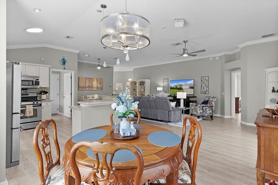 An expansive, open-concept space flows seamlessly from dining table to living area to kitchen—perfect for gathering, relaxing, and making memories together.