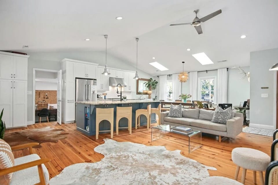 The kind of open-concept space where everyone naturally gravitates together - cook at the island, lounge on the sofa, or pull up a chair at the dining table without missing a beat