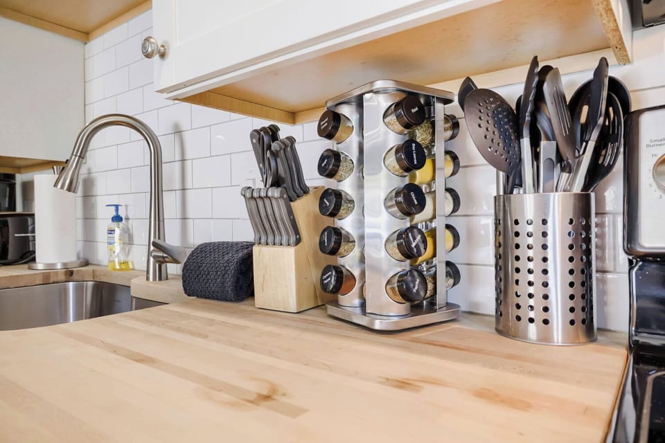 You'll love preparing meals on these beautiful butcher block counters, outfitted with quality knives, utensils, and spices—everything you need at your fingertips.